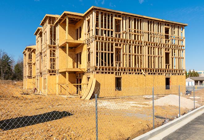 a temporary chain link fence in front of a building under construction, ensuring public safety in Mascoutah IL